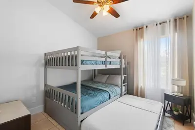 a bedroom with two bunk beds and a ceiling fan at Magic & Comfort in the Palms!Near Disney-Universal in Kissimmee