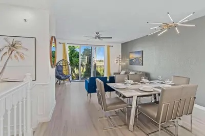 a dining room and living room with a table and chairs at 8036 Spacious Fresh 3BR3.5BA at Vista Cay 133 in Orlando