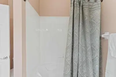 a shower curtain in the corner of a bathroom at 3-Story sanctuary Condo in the heart of Orlando85 in Orlando