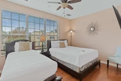 a bedroom with two beds and a ceiling fan at 3-Story sanctuary Condo in the heart of Orlando85 in Orlando