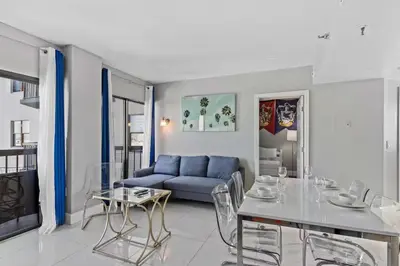 a living room with a blue couch and a table at 2701 Enclave Condo near Univesal-Lakeview in Orlando