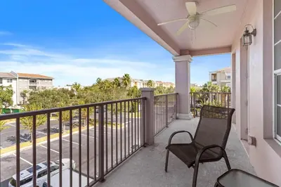 a balcony with a chair and a ceiling fan at 4840 A Hidden Gem in the Heart of Orlando – 303 in Orlando
