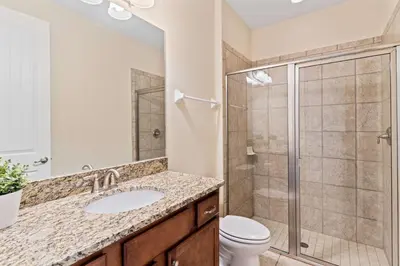 a bathroom with a shower and a sink and a toilet at 500 Luxurious 8BR Villa with Private PoolSpa in Orlando