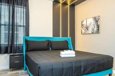 a bedroom with a blue bed in a room at Stunning Masterpiece 15 ensuites in Kissimmee