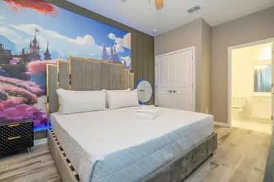 a bedroom with a disney mural on the wall at Stunning Masterpiece 15 ensuites in Kissimmee
