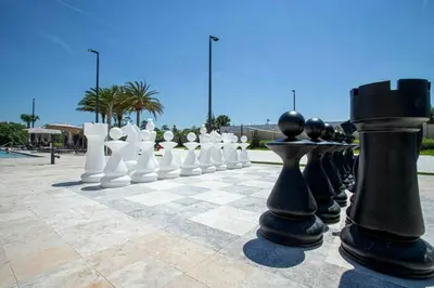 a chess board with black and white pieces on it at Modern 4bed townhome in the heart of Kissimmee in Orlando