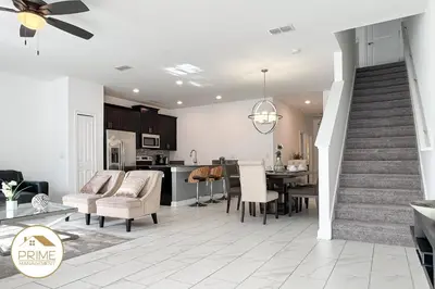 a kitchen and living room with a dining room and a kitchen and a dining table at New Themed Rooms5BR Near AttractionsResort in Kissimmee