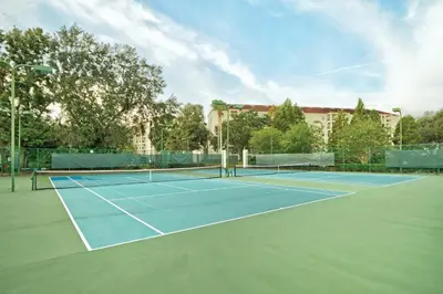a tennis court with two tennis rackets on it at Wyndham Star Island Resort 1BR Apartment with Resort Access in Kissimmee