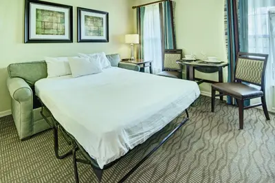 a hotel room with a large bed and a couch at Wyndham Star Island Resort 1BR Apartment with Resort Access in Kissimmee
