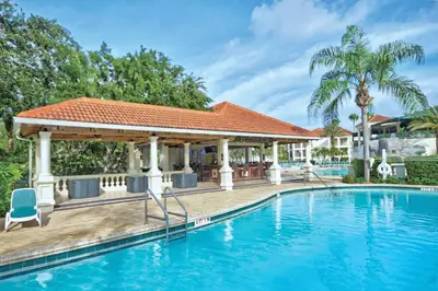a swimming pool with a gazebo next to a house at Wyndham Star Island Resort 1BR Apartment with Resort Access in Kissimmee