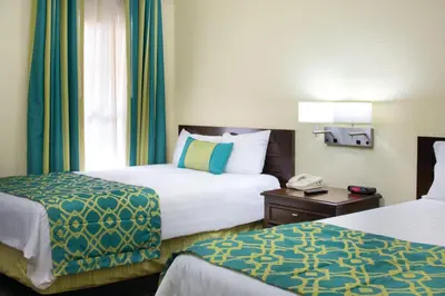 a hotel room with two beds and a phone at Wyndham Star Island Resort 2BR Apartment with Resort Access in Kissimmee