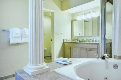 a bathroom with a sink and a large mirror at Wyndham Star Island Resort 2BR Apartment with Resort Access in Kissimmee