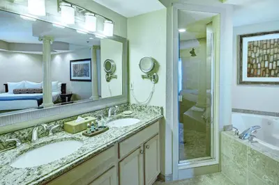 a bathroom with two sinks and a shower at Wyndham Star Island Resort 3BR Apartment with Resort Access in Kissimmee