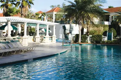 a swimming pool at a resort with palm trees at Wyndham Star Island Resort 3BR Apartment with Resort Access in Kissimmee