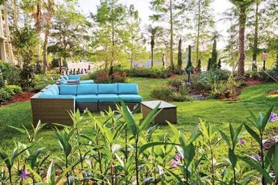 a blue couch sitting in the middle of a garden at Wyndham Cypress Palms 2BR Apartment with Resort Access in Kissimmee