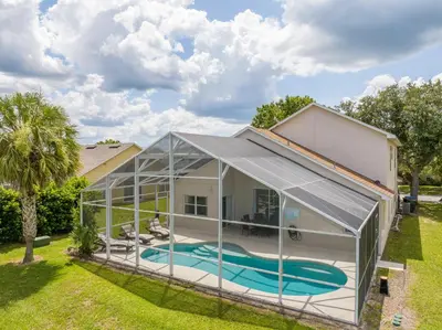 an exterior view of a greenhouse with a swimming pool at Amazing 6 bedrooms with pool in Kissimmee