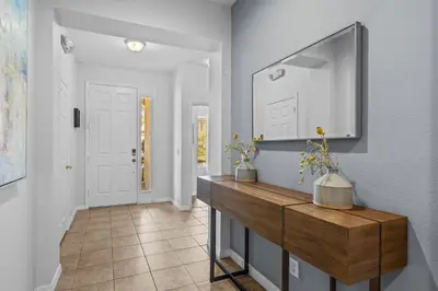 a bathroom with a large mirror and a counter at Family Nest 4-Bedroom Home Near Disney World in Kissimmee