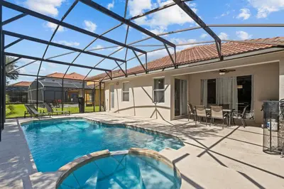 a swimming pool with a glass roof over a house at Family Nest 4-Bedroom Home Near Disney World in Kissimmee
