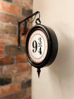 a clock hanging on the side of a wall at Harry Potter Suite near Epic & Universal in Orlando