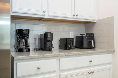 a kitchen counter with two coffees and a coffee maker at Paradiso Grande 6 bedroom New Home - 10377 in Orlando