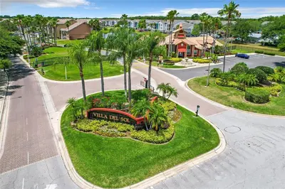 an aerial view of a park with palm trees and a sign at Adventure's at Villa Del Sol in Kissimmee