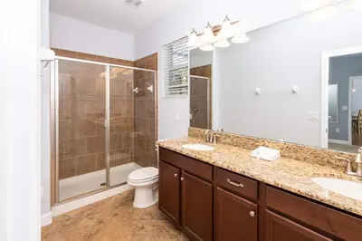 a bathroom with two sinks and a shower at Adventurers Oasis - Private pool in Kissimmee