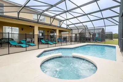 a swimming pool with a glass roof over it at Be Our Guest at Emerald Island in Kissimmee