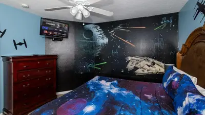 a bedroom with a star wars mural on the wall at Be Our Guest at Emerald Island in Kissimmee