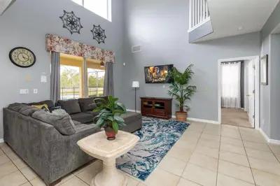 a living room with a couch and a table at Be Our Guest at Emerald Island in Kissimmee