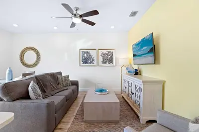 a living room with a couch and a ceiling fan at Capri Sunset in Orlando