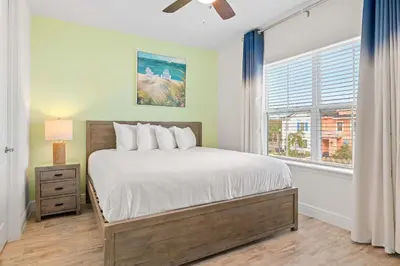 a bedroom with a bed and a window at Capri Sunset in Orlando