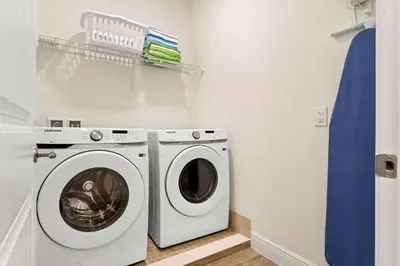 a laundry room with a washer and dryer at Capri Sunset in Orlando