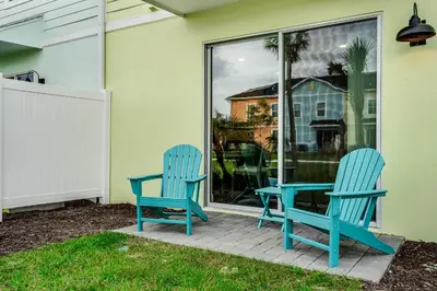 two blue chairs and a table on a patio at Caribbean Dreamin - Vibrant Margaritaville Resort in Orlando
