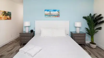 a bedroom with a large white bed with two night stands at Caribbean Summer - Serene Patio in Orlando