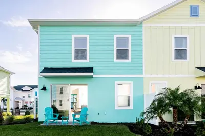 a blue house with two blue chairs in the front yard at Caribbean Summer - Serene Patio in Orlando