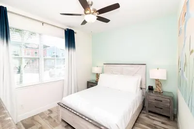 a bedroom with a bed and a ceiling fan at Caribbean Summer - Serene Patio in Orlando