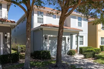 a building with trees in front of it at Casa de Kissimmee Sleeps up to 13 Guests in Kissimmee