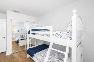 a room with two bunk beds and a mirror at Celebrate at Club Cortile in Kissimmee