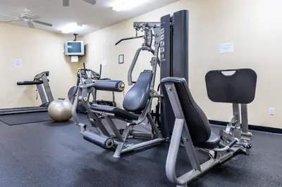 a gym with several tread machines in a room at Celebrate at Club Cortile in Kissimmee