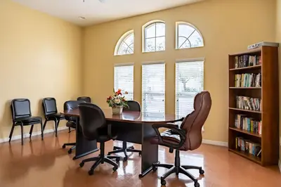 a meeting room with a table and chairs at Celebrate at Club Cortile in Kissimmee