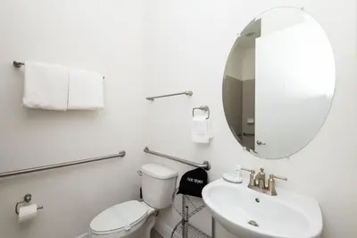 a bathroom with a toilet and a sink and a mirror at Coconut Cabana - Access 4 Most in Orlando
