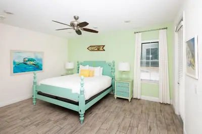 a bedroom with a bed and a ceiling fan at Coconut Cabana - Access 4 Most in Orlando