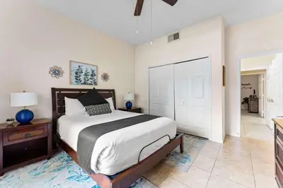 a bedroom with a large bed and a closet at Cozy Cove - Caribe Escape for 8 in Orlando