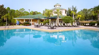 a swimming pool in front of a house at Cozy Cove - Caribe Escape for 8 in Orlando