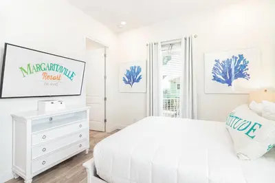 a white bedroom with a bed and a tv at Shake Shack - Heated Pool-NO Fee & Hot Tub in Orlando