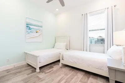 two beds in a white room with a window at Shake Shack - Heated Pool-NO Fee & Hot Tub in Orlando