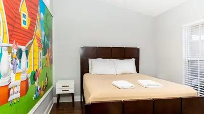 a bedroom with a bed and a painting on the wall at Wonderland at White Crane - Hot tub & Lake views in Orlando