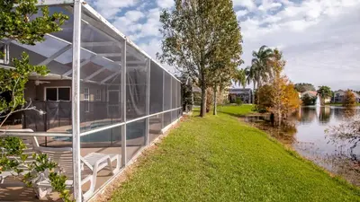 a glass house next to a river at Wonderland at White Crane - Hot tub & Lake views in Orlando