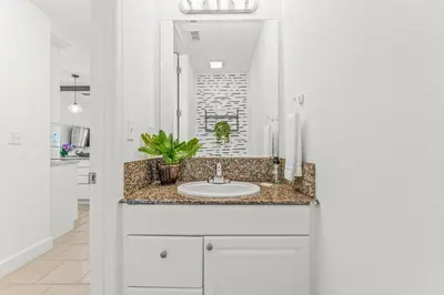 a bathroom with a sink and a mirror at Family Friendly Relax Villa in Kissimmee