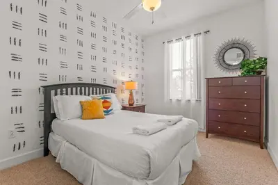 a bedroom with a bed and a dresser and a mirror at Family Friendly Relax Villa in Kissimmee